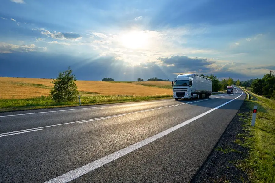 Inland-Marine-Insurance-Truck-Moving-Along-the-Road-Transporting-Goods-min