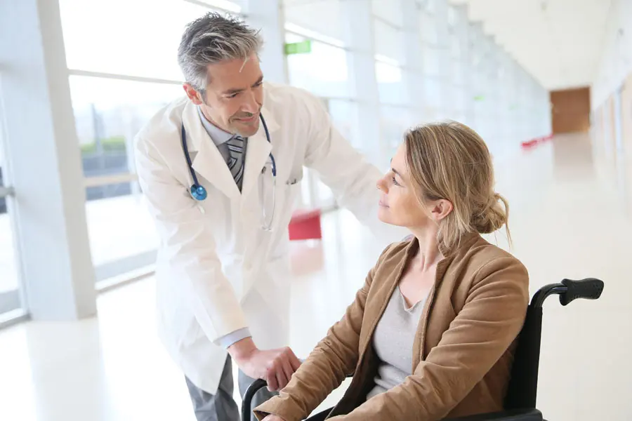 Long-Term-Care-Insurance-Nurse-Helping-a-Woman-Walk-min