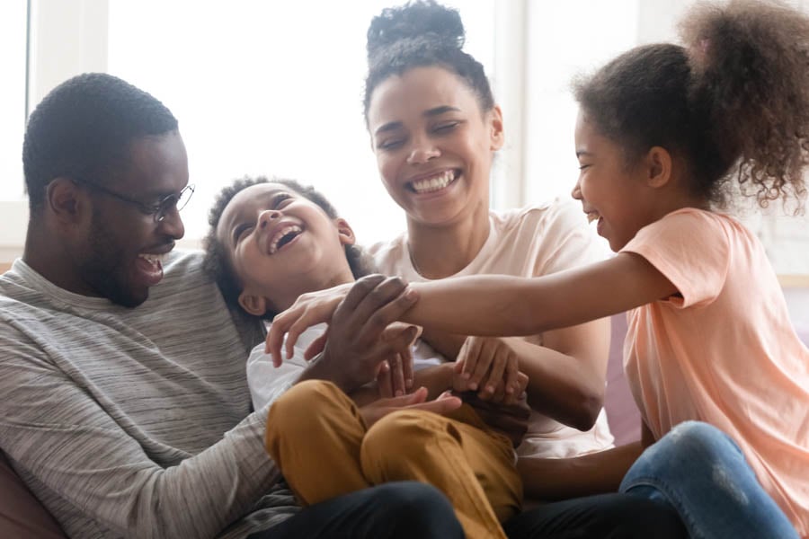 About Our Agency - Happy Family Hanging Out in the Living Room Together at Home
